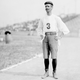 Cuban long-distance runner Félix de la Caridad Carvajal y Soto, known as Andarín Carvajal, standing on the track of an athletic field in St. Louis, Missouri, during the 1904 Olympic Games